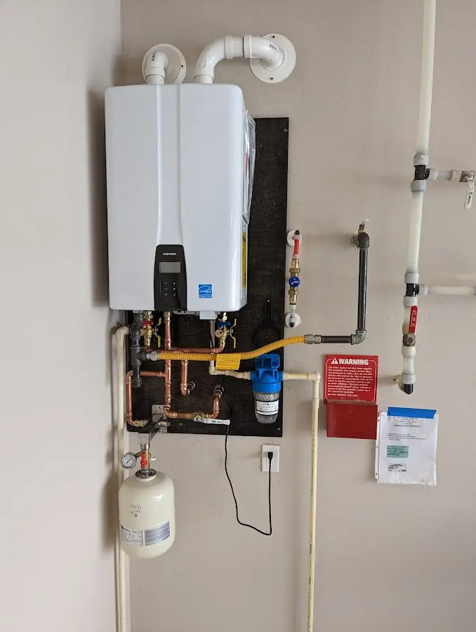 Professional plumber installing copper piping in a Crystal Lake home